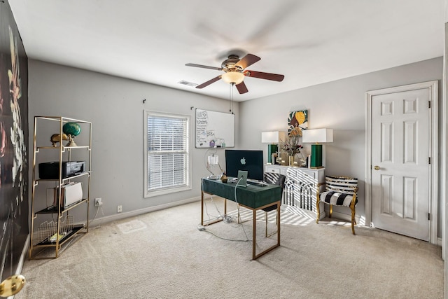 office area with carpet floors, visible vents, baseboards, and a ceiling fan