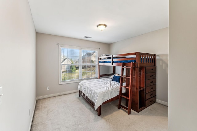 carpeted bedroom featuring visible vents and baseboards