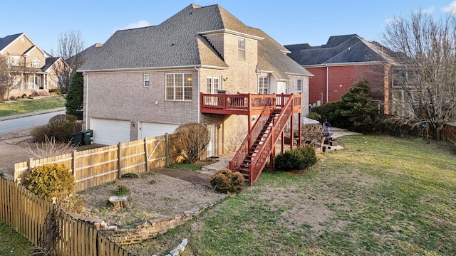 back of property with brick siding, stairway, an attached garage, fence, and a wooden deck