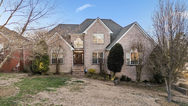 traditional-style house featuring brick siding