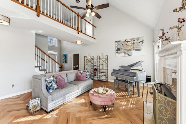 living room featuring baseboards, a fireplace, and high vaulted ceiling