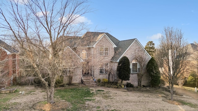 traditional-style house featuring brick siding