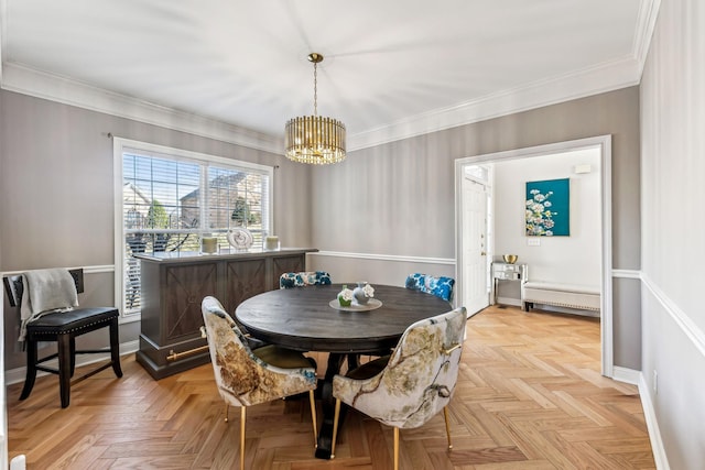 dining area with an inviting chandelier, baseboards, and crown molding