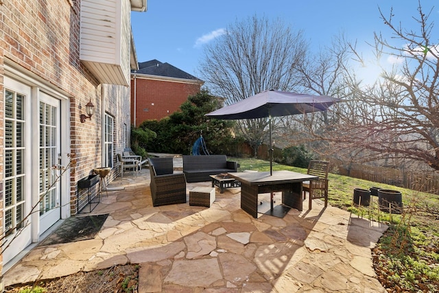 view of patio / terrace with french doors and an outdoor living space with a fire pit