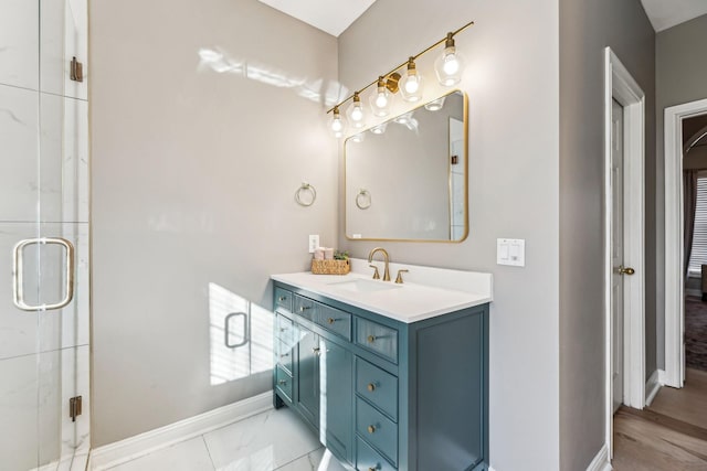 bathroom featuring a stall shower, vanity, and baseboards