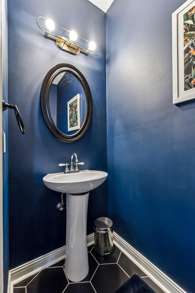 bathroom with baseboards and tile patterned floors