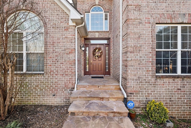 property entrance featuring brick siding