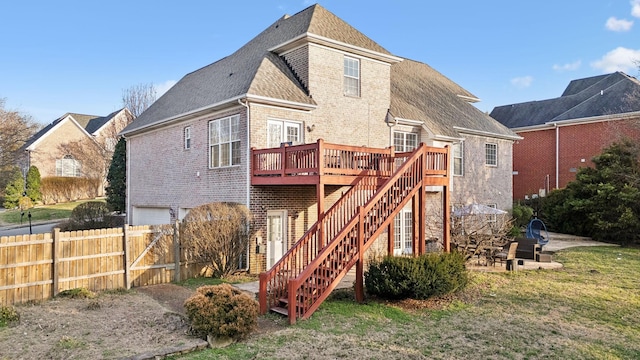 rear view of house with a patio, a garage, fence, stairway, and a wooden deck