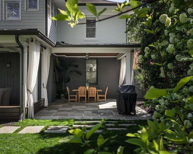 rear view of house featuring a patio and outdoor dining area