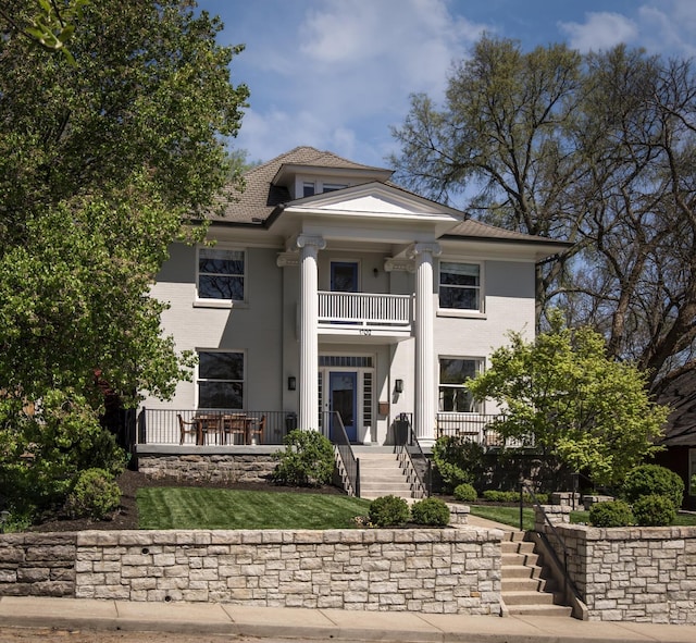 neoclassical home with a balcony