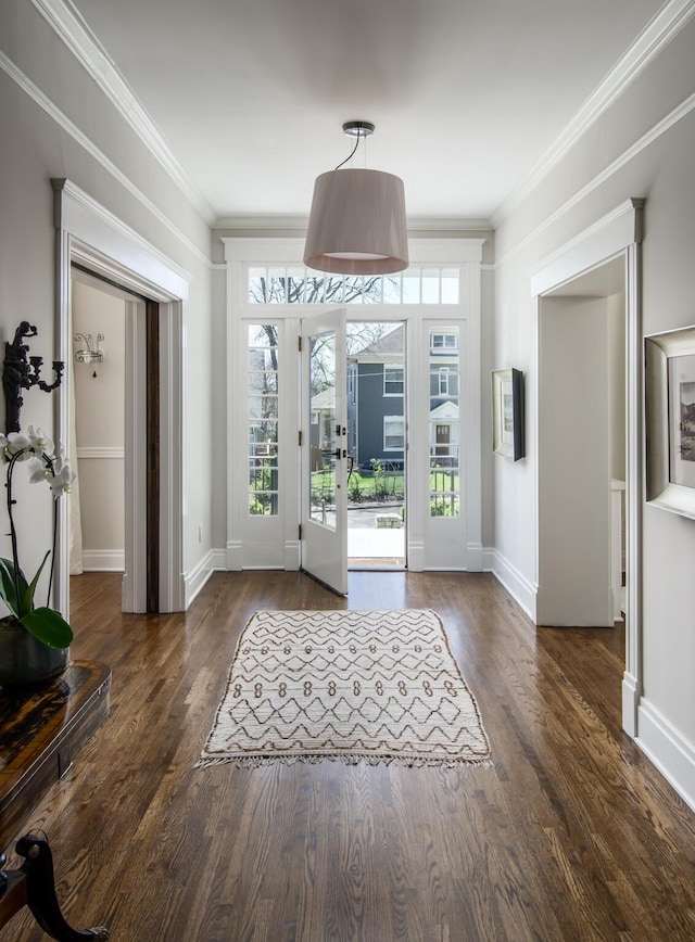 doorway with ornamental molding, french doors, baseboards, and wood finished floors