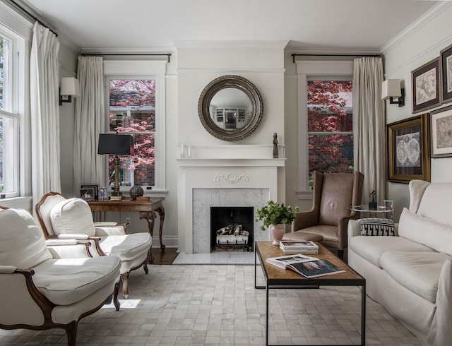 sitting room featuring a premium fireplace and crown molding