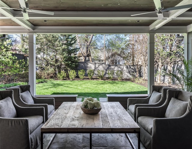 sunroom / solarium with beamed ceiling, coffered ceiling, and a ceiling fan