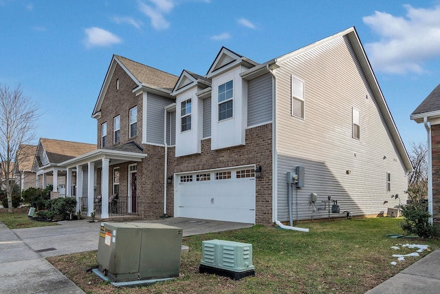 view of home's exterior with a garage, a yard, concrete driveway, and brick siding