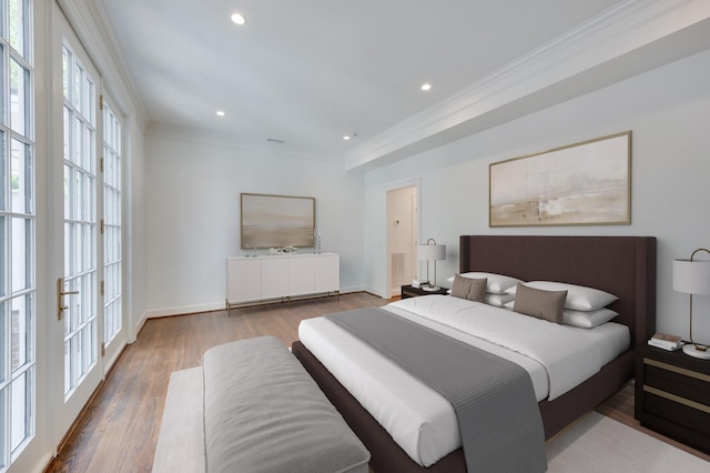 bedroom featuring baseboards, recessed lighting, wood finished floors, and crown molding