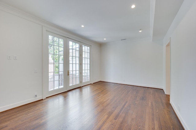 spare room with baseboards, dark wood-style flooring, recessed lighting, and crown molding