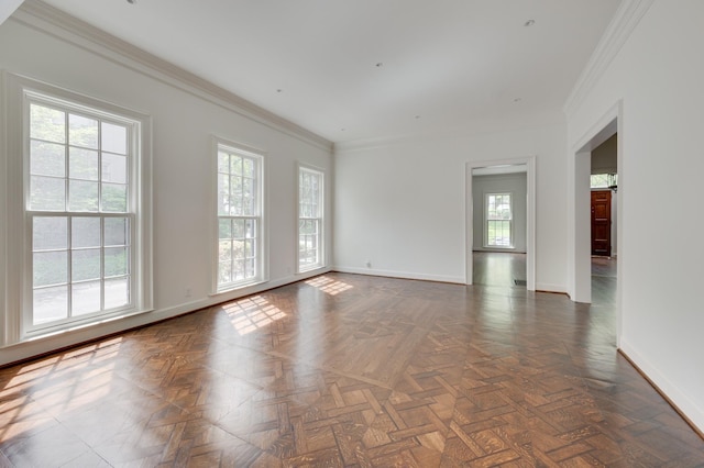 empty room with baseboards and crown molding