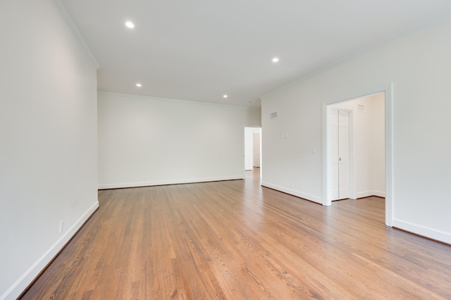 unfurnished room with recessed lighting, crown molding, baseboards, and wood finished floors