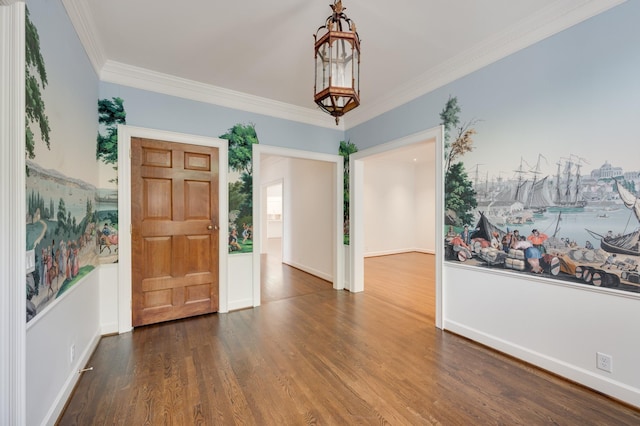 foyer featuring baseboards, crown molding, an inviting chandelier, and wood finished floors