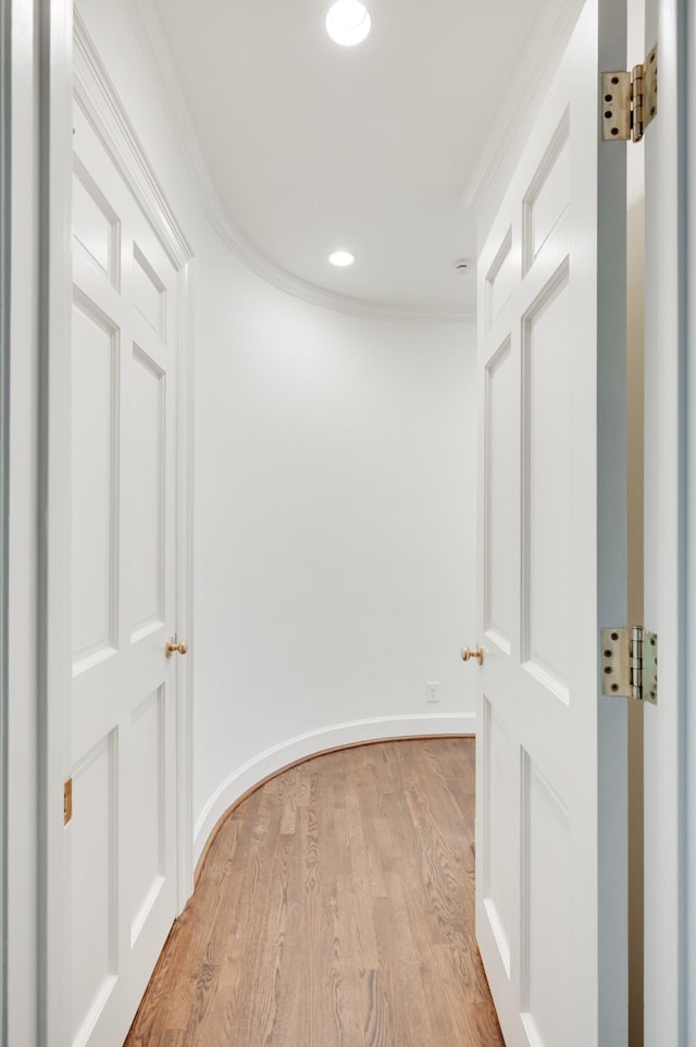 hallway with crown molding, recessed lighting, baseboards, and light wood-style floors