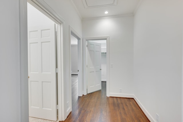 hallway with baseboards, dark wood finished floors, crown molding, and recessed lighting