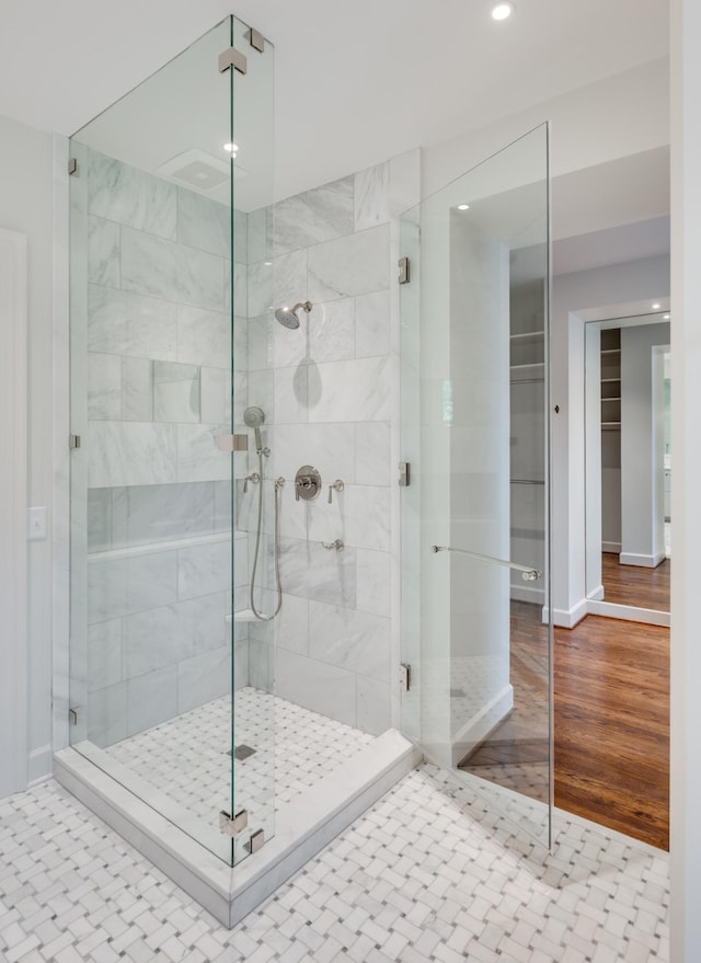 full bath with a stall shower, recessed lighting, wood finished floors, and baseboards