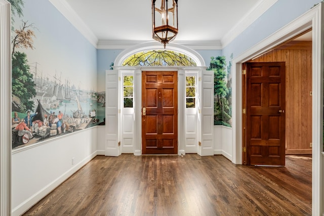 entrance foyer featuring ornamental molding, dark wood-style flooring, and baseboards