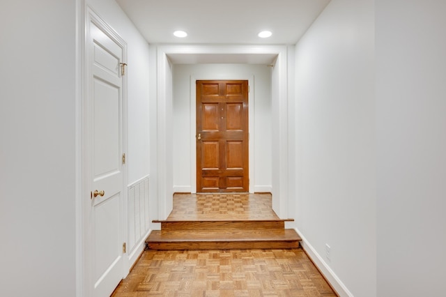 doorway with parquet floors, recessed lighting, visible vents, and baseboards