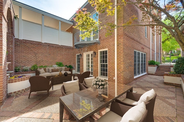 view of patio / terrace featuring a balcony and an outdoor living space