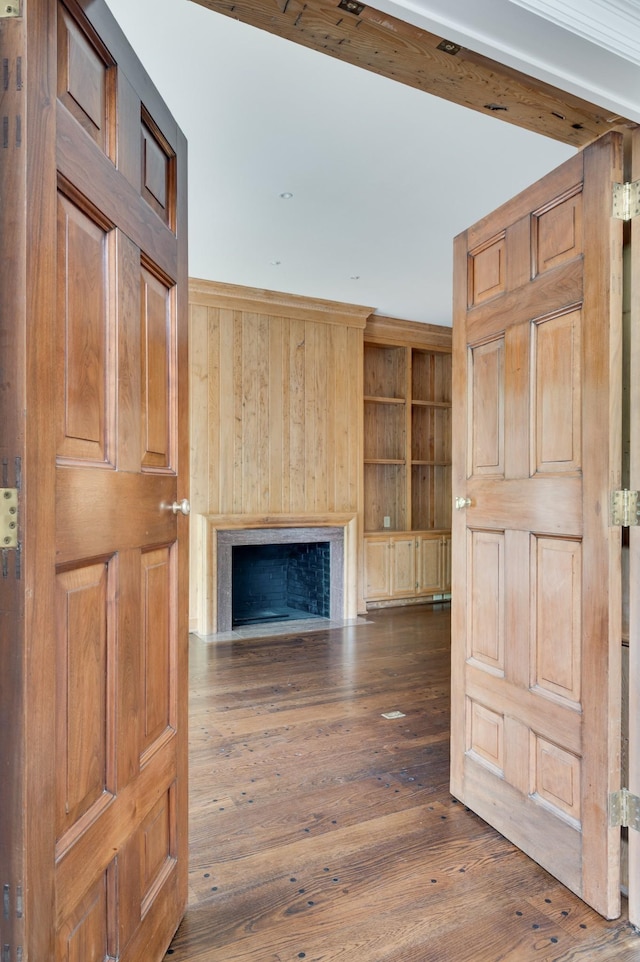 unfurnished living room featuring a fireplace with flush hearth and dark wood-style floors