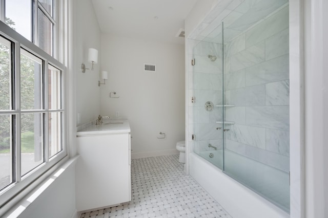 full bath with visible vents, toilet, vanity, shower / tub combination, and baseboards