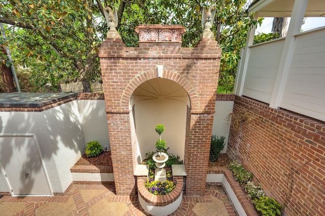 exterior space featuring a fireplace and fence