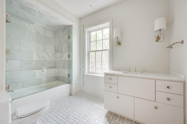 full bathroom featuring toilet, shower / bath combination, baseboards, and vanity