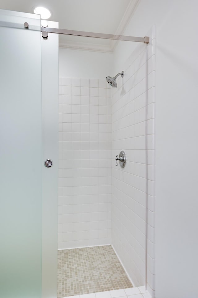 bathroom featuring a stall shower and crown molding