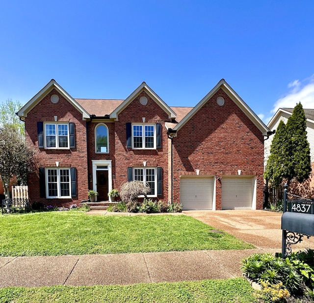 colonial home with concrete driveway, a front lawn, and brick siding