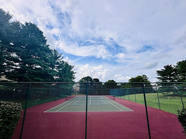 view of sport court featuring fence