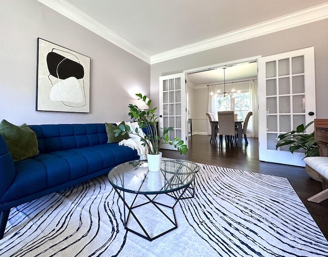 living area featuring ornamental molding, french doors, an inviting chandelier, and wood finished floors