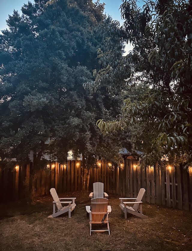 view of yard with a fire pit and fence