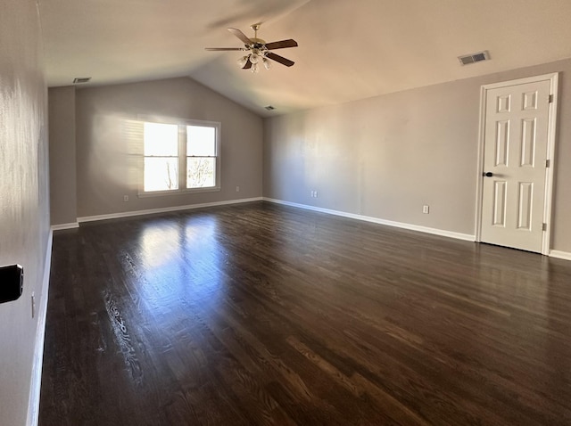 unfurnished room featuring ceiling fan, dark wood-type flooring, lofted ceiling, and visible vents