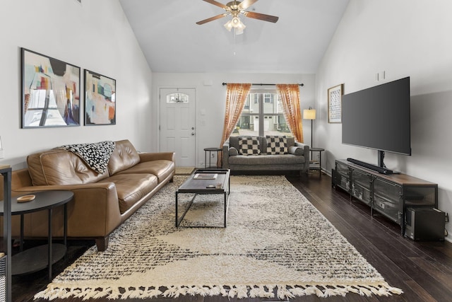 living area featuring ceiling fan, high vaulted ceiling, and dark wood finished floors