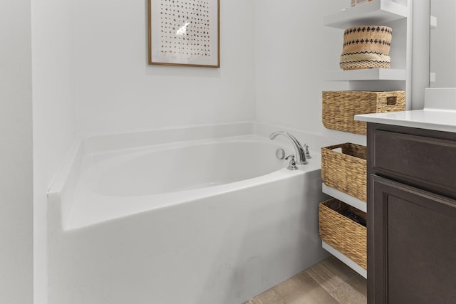 bathroom with vanity and a bath