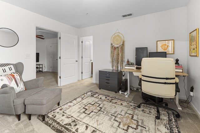 carpeted office space featuring visible vents and baseboards