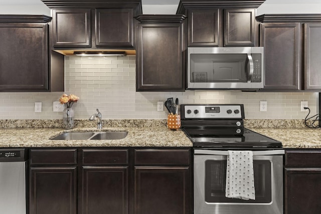 kitchen with stainless steel appliances, a sink, and dark brown cabinets