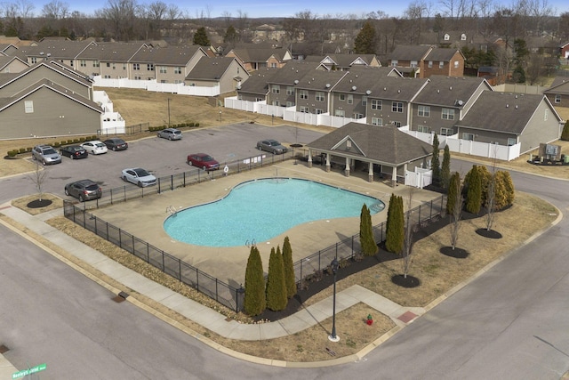 view of pool with a fenced in pool, a residential view, fence, and a patio