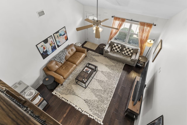 living area featuring baseboards, ceiling fan, visible vents, and wood finished floors