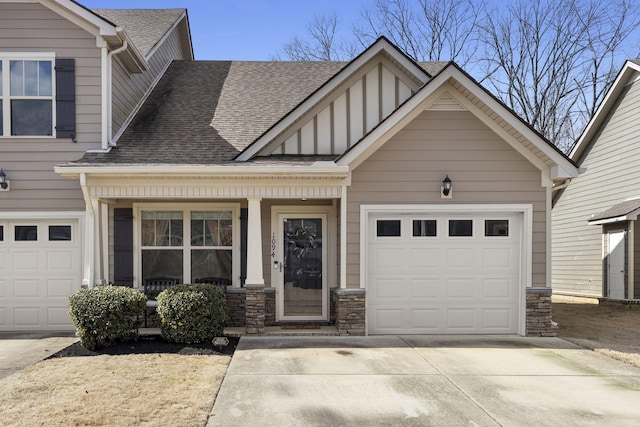 view of front of house with concrete driveway, a shingled roof, an attached garage, and stone siding