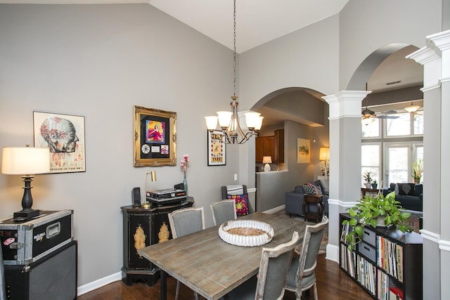 dining room with decorative columns, arched walkways, dark wood-style flooring, high vaulted ceiling, and ceiling fan with notable chandelier