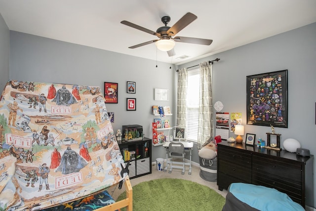 carpeted bedroom featuring a ceiling fan, visible vents, and baseboards