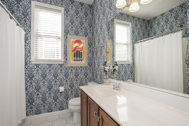 full bathroom featuring toilet, vanity, tile patterned flooring, baseboards, and wallpapered walls