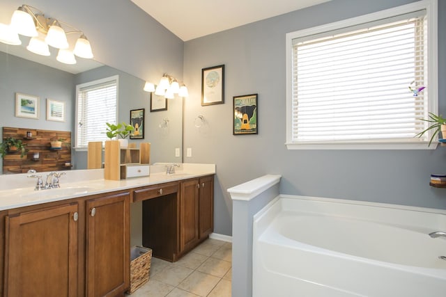 bathroom with double vanity, tile patterned flooring, a sink, and a bath